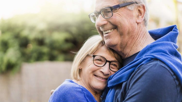 Senior couple embracing each other in backyard Senior couple embracing each other in backyard